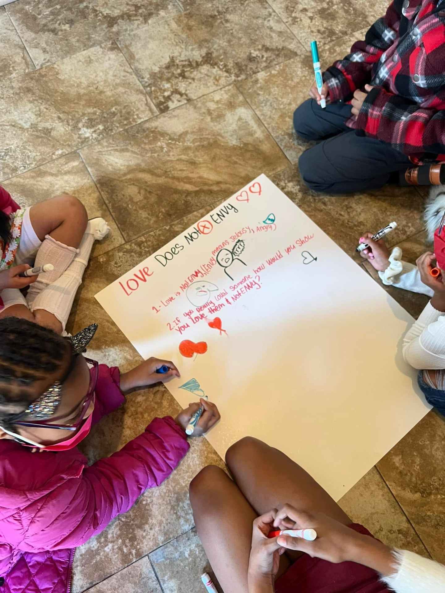 Children drawing a lesson about love together